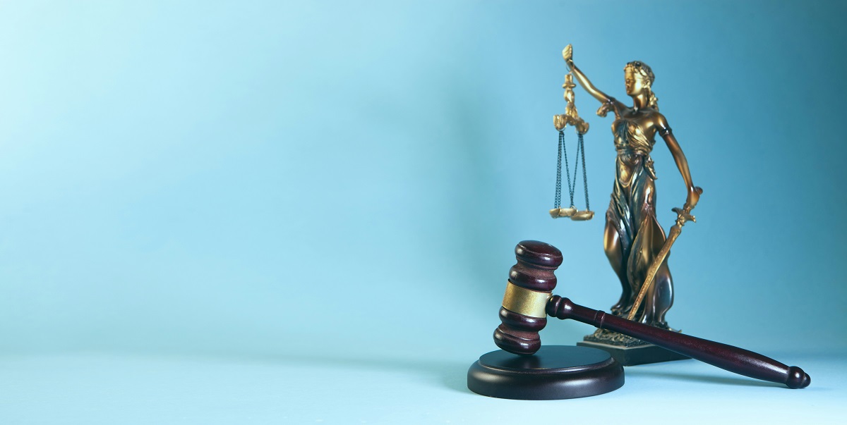 lady justice statuette and wooden gavel